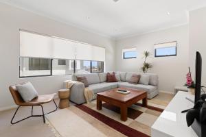 a living room with a couch and a table at Walk to the Mandurah Foreshore & Marina in Mandurah