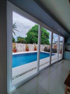a view of a swimming pool from a room with windows at Beachfront With 2 Bedrooms and Pool for 20 in San Juan