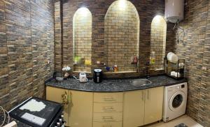 a bathroom with a sink and a washing machine at The House Of Love in Luxor +47 photos