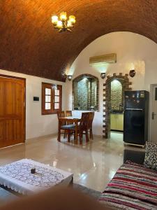 a kitchen and dining room with a table and chairs at The House Of Love in Luxor