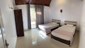a bedroom with two beds and a window at The House Of Love in Luxor