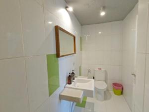 a bathroom with a sink and a toilet and a mirror at Villa PhyPhy in Gili Trawangan