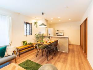 a kitchen and living room with a table and chairs at 巡り宿香西本町-最大10名 in Takamatsu