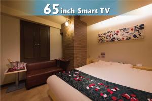 a hotel room with a bed and a couch at Hotel Will池袋 Adult Only in Tokyo