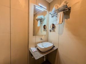 a small bathroom with a sink and a mirror at Zip by Spree Hotels Shirdi - Walkable Distance from Sai Baba Temple in Shirdi +26 photos