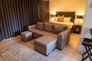 a bedroom with a bed and a couch and a couch and a chair at Harmony House in Ladysmith