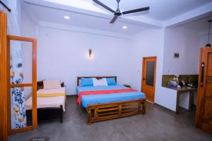 a bedroom with two beds and a ceiling fan at Seyoo Villa in Ahangama