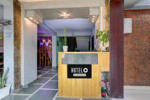 a lobby with a hotel sign on a counter at Super Hotel O Dadri Main Road Greater Noida in Greater Noida