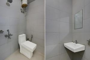 a white bathroom with a toilet and a sink at Super Hotel O Dadri Main Road Greater Noida in Greater Noida