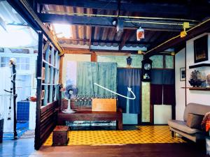 a room with a couch and a table in a room at Gumm Lonely Club in Ko Kood