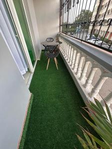 an empty balcony with green grass on the floor at SaltyNest in Gatunga
