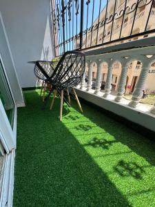 a bench sitting on a balcony with green grass at SaltyNest in Gatunga
