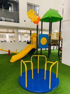 a playground with a slide and an umbrella at Angelic stay in Hulhumale