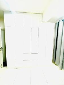 a bathroom with white cabinets and a window at Angelic stay in Hulhumale +16 photos