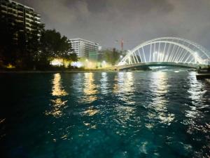 a bridge over a body of water at night at Angelic stay in Hulhumale