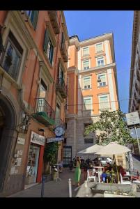 a woman walking down a street in front of a building at Casa Ilaria in Naples