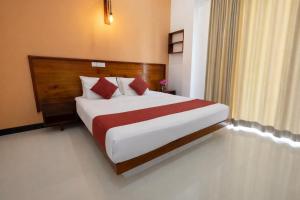 a bedroom with a large bed in a hotel room at Sea Cloud Dalawalle in Unawatuna