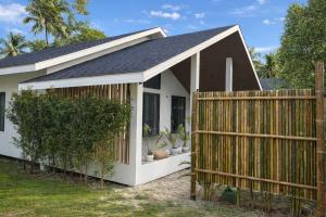 a house with a wooden fence in front of it at Cocolane Villa 4 in Hinkong