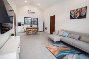 a living room with a couch and a table at Cocolane Villa 4 in Hinkong