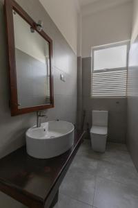 a bathroom with a sink and a toilet at Sea Cloud Dalawalle in Unawatuna +36 photos