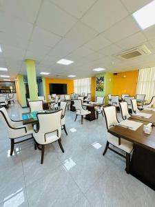 a waiting room with tables and chairs and a classroom at KIJICHI GATEWAY Hotel in Dar es Salaam