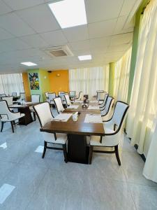 a conference room with a long table and chairs at KIJICHI GATEWAY Hotel in Dar es Salaam