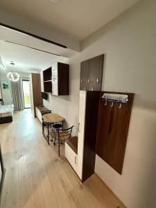 a living room with a kitchen and a dining room at Cozy Ski-In Studio near forest at Crystal residence in Bakuriani