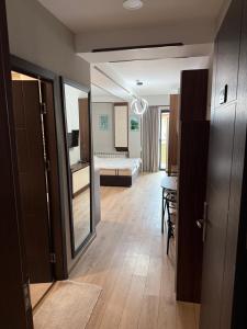 a room with a bedroom with a bed and a table at Cozy Ski-In Studio near forest at Crystal residence in Bakuriani +18 photos