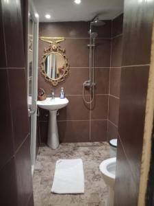 a bathroom with a sink and a toilet and a mirror at Metropolis studio in Corfu +26 photos