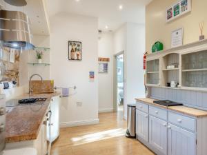 a kitchen with white cabinets and a counter top at Walnut Cottage - Ukc6632 in Pentney