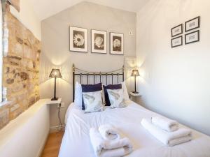 a bedroom with a bed with towels on it at Walnut Cottage - Ukc6632 in Pentney +7 photos