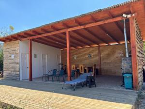 a patio with awning and chairs and a table at Cabañas Cocodrilo Lodge in Molina +23 photos