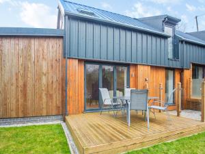 a wooden deck with a table and chairs on it at Arenig View - Uk51068 in Frongoch
