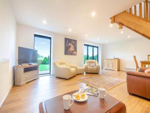a living room with a couch and a tv at Arenig View - Uk51068 in Frongoch
