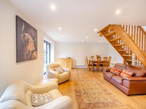 a living room with a couch and a staircase at Arenig View - Uk51068 in Frongoch