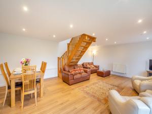 a living room with a staircase and a dining room at Arenig View - Uk51068 in Frongoch +13 photos