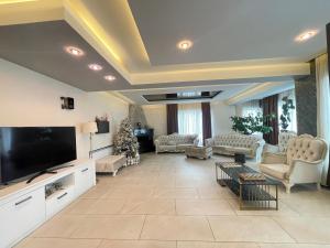a large living room with a large flat screen tv at Villa san maria in Bakuriani