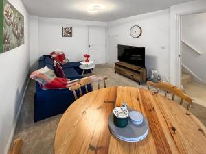 a living room with a table and a couch at Richborough House in Saint Peters
