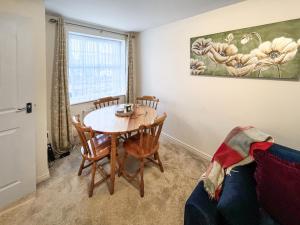 a living room with a table and chairs and a couch at Richborough House in Saint Peters
