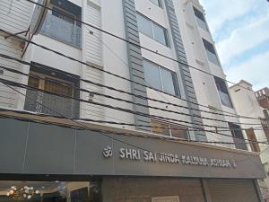 a building with a sign on the front of it at Gokul Dham in Haridwār