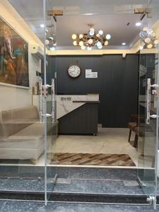 a lobby with a clock on the wall and a desk at Gokul Dham in Haridwār +33 photos