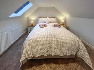 a bedroom with a bed and two night stands at Taigh-Beag - Uk50660 in Wigtown