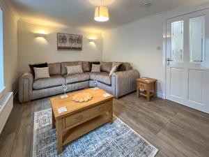a living room with a couch and a coffee table at Taigh-Beag - Uk50660 in Wigtown