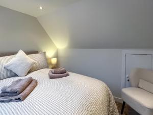 a bedroom with a bed with towels on it at Taigh-Beag - Uk50660 in Wigtown +5 photos