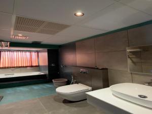 a bathroom with a toilet and a sink at WINTEL WILD in Vālpārai +52 photos