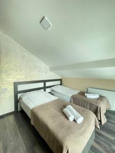 a room with two beds with towels on them at Villa san maria in Bakuriani