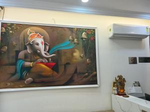 a large painting of an elephant on a wall at Gokul Dham in Haridwār