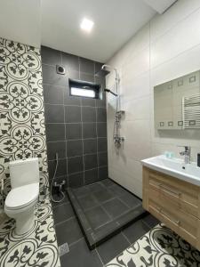 a bathroom with a toilet and a sink at Villa san maria in Bakuriani +37 photos
