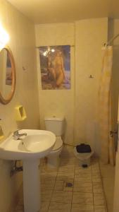 a bathroom with a sink toilet and a painting on the wall at HELLAS PALACE ROOM PRIVATE in Sparta +75 photos