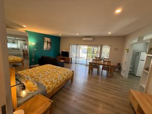 a bedroom with a bed and a living room at Boyanup West Wing in Boyanup